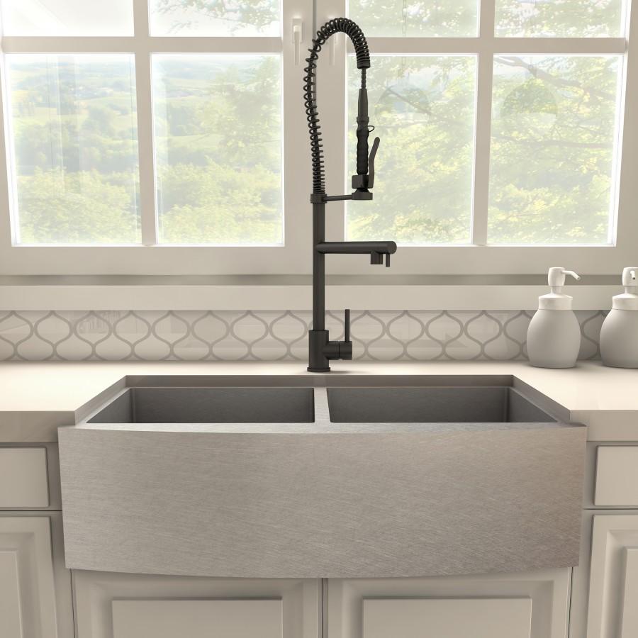 Matte black kitchen faucet over single-basin sink with pull-down sprayer.