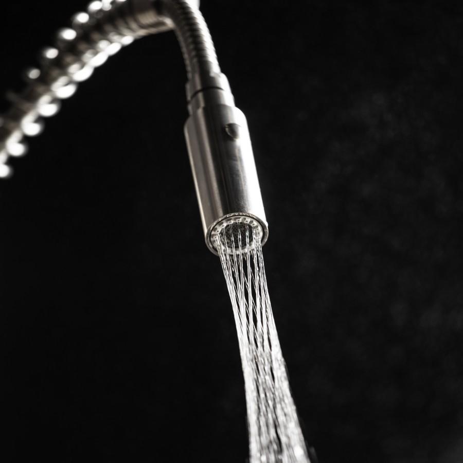 Matte black kitchen faucet with arched spout and handheld spray head
