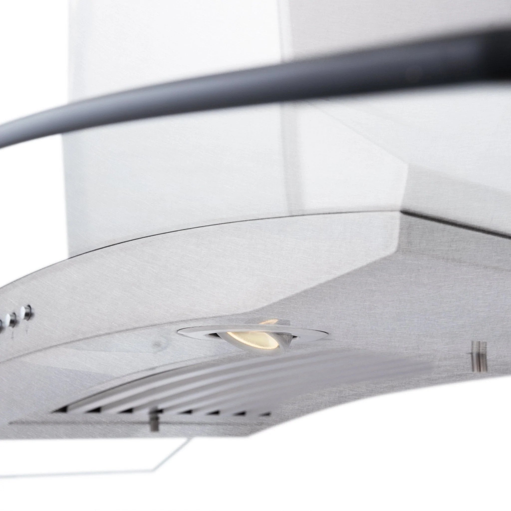 Satin stainless range hood underside with vent louvers and round light window